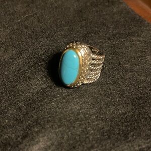 Simulated Turquoise blue Oval Stone with gold tone rim. Statement Ring